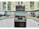 Well-equipped kitchen boasts modern stainless steel appliances and stylish backsplash at 250 Little Oak Island Dr, Folly Beach, SC 29439