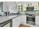Bright kitchen featuring white cabinets, a stainless steel oven, and marble countertops at 250 Little Oak Island Dr, Folly Beach, SC 29439