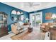 Comfortable living room with blue walls, vintage furniture, and access to a patio at 250 Little Oak Island Dr, Folly Beach, SC 29439