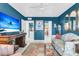 Living room with blue walls, vintage furniture and decor, and a view into the kitchen at 250 Little Oak Island Dr, Folly Beach, SC 29439
