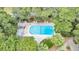 Community pool with mature trees, chairs and pergolas at 250 Little Oak Island Dr, Folly Beach, SC 29439