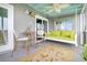 Cozy screened porch with a swing bed, seating area, and ceiling fan at 250 Little Oak Island Dr, Folly Beach, SC 29439