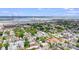 Aerial view showcasing homes, trees, and a waterfront with a bridge in the background at 29 Hanover St, Charleston, SC 29403