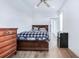 Cozy bedroom with hardwood floors, wooden dresser, queen bed and a mini refrigerator at 29 Hanover St, Charleston, SC 29403