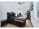 Spacious bedroom with hardwood floors, a ceiling fan, tv, and ample storage at 29 Hanover St, Charleston, SC 29403