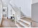 Bright entryway with stairs, wood floors, and a small table with chairs at 29 Hanover St, Charleston, SC 29403