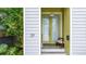 A close-up of the home's entrance, which showcases the front door, number and a charming chair at 29 Hanover St, Charleston, SC 29403