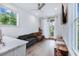 Cozy living room area with hardwood floors, ample natural light, a view of the kitchen, and access to the outdoors at 29 Hanover St, Charleston, SC 29403