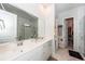Modern bathroom with dual sinks, white cabinets, and a glass-enclosed shower at 290 Woodland Oak Way, Summerville, SC 29485