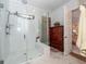 Modern bathroom featuring a glass-enclosed shower with white tiling and a decorative wooden cabinet at 290 Woodland Oak Way, Summerville, SC 29485