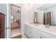 Bright bathroom boasts double sinks with white cabinets and a view into the bedroom at 290 Woodland Oak Way, Summerville, SC 29485