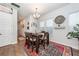 The dining room is adorned with a rustic wood table and colorful rug, creating a warm and inviting space at 290 Woodland Oak Way, Summerville, SC 29485