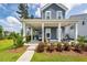 Inviting front porch with stylish seating, decorative plants, and white columns, perfect for relaxing outdoors at 290 Woodland Oak Way, Summerville, SC 29485