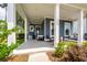 Close-up of the spacious covered porch with comfortable seating and attractive details at 290 Woodland Oak Way, Summerville, SC 29485
