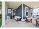 Spacious covered porch furnished with cozy seating arrangements at 290 Woodland Oak Way, Summerville, SC 29485