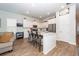 Open concept kitchen with a large center island, seating, and stainless steel appliances that flows into the living room at 290 Woodland Oak Way, Summerville, SC 29485