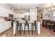 Spacious open-concept kitchen with an island featuring seating, white cabinets, and stainless steel appliances at 290 Woodland Oak Way, Summerville, SC 29485