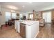 Open-concept kitchen features a large island with stainless steel dishwasher and seating, connecting to living and dining areas at 290 Woodland Oak Way, Summerville, SC 29485