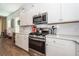 This bright kitchen features stainless steel appliances, white cabinets, and subway tile backsplash at 290 Woodland Oak Way, Summerville, SC 29485