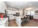 Spacious kitchen with white cabinets, stainless appliances, a large island with seating, and an adjacent dining area at 290 Woodland Oak Way, Summerville, SC 29485