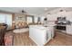 Modern kitchen with white cabinetry, stainless steel appliances, and an island that opens to the living area at 290 Woodland Oak Way, Summerville, SC 29485