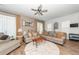 Well-lit living room with ample seating, neutral tones, a ceiling fan, and a cozy atmosphere for relaxation at 290 Woodland Oak Way, Summerville, SC 29485