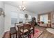 Dining area with a wooden table, stylish rug, and views into the living room at 290 Woodland Oak Way, Summerville, SC 29485