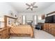 Spacious main bedroom with a ceiling fan, king bed, and wooden furniture at 290 Woodland Oak Way, Summerville, SC 29485