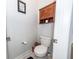 Compact powder room with a toilet and a small cabinet at 290 Woodland Oak Way, Summerville, SC 29485