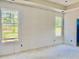 Bedroom with bright windows featuring drywall ready for paint, perfect for creating your oasis at 3006 Abagail Ct, North Charleston, SC 29406