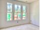 Bedroom featuring bright windows and drywall ready for paint, creating a customizable space at 3006 Abagail Ct, North Charleston, SC 29406