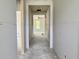 Hallway showcasing walls ready for paint, and a view into the next room with bright windows at 3006 Abagail Ct, North Charleston, SC 29406