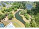 Aerial view of a community featuring a pond, walking trails, a playground and pool with tennis courts surrounded by trees at 3010 Grinnell St, Johns Island, SC 29455