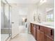 Bright bathroom with double sink vanity, walk-in shower, and access to main bedroom at 3010 Grinnell St, Johns Island, SC 29455