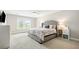 Comfortable bedroom with a large window, ceiling fan, and a cozy bed with decorative pillows at 3010 Grinnell St, Johns Island, SC 29455