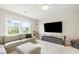 Bright bonus room with a large sectional, a window with natural light, and a television at 3010 Grinnell St, Johns Island, SC 29455