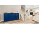 Stylish entryway with blue accent cabinet, staircase, and view of living room with fireplace at 3010 Grinnell St, Johns Island, SC 29455