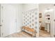 Inviting entryway featuring a coat rack with hooks, a wooden bench, and access to the bathroom at 3010 Grinnell St, Johns Island, SC 29455