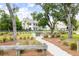 Fire pit area with Adirondack chairs and string lights in a lush outdoor community setting at 3010 Grinnell St, Johns Island, SC 29455