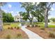 Outdoor fire pit area with Adirondack chairs and string lights, perfect for relaxation in this beautiful community at 3010 Grinnell St, Johns Island, SC 29455