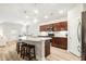 Open-concept kitchen boasting stainless steel appliances, granite countertops, kitchen island and bar stool seating at 3010 Grinnell St, Johns Island, SC 29455