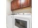 Laundry room with dark cabinets, white washer and dryer at 3010 Grinnell St, Johns Island, SC 29455