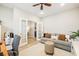 Well-lit home office with gray walls, wood floors, ceiling fan, comfortable seating and glass paneled french doors at 3010 Grinnell St, Johns Island, SC 29455