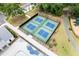 Aerial view of four blue and green pickleball courts, pool with lounge chairs and playground in this active community at 3010 Grinnell St, Johns Island, SC 29455