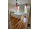 Cozy bedroom features hardwood floors, white bedding, and bright natural light at 324 Wild Horse Ln, Mount Pleasant, SC 29464