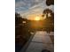 Outdoor deck at sunset featuring a table setting for dining with glass and a palm tree at 324 Wild Horse Ln, Mount Pleasant, SC 29464