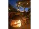 Cozy deck with fire pit, string lights, pergola, and comfortable seating at 324 Wild Horse Ln, Mount Pleasant, SC 29464