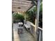 Outdoor deck featuring a wooden pergola, a bench, table, grill, and lush greenery for relaxation and entertainment at 324 Wild Horse Ln, Mount Pleasant, SC 29464