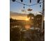 Relaxing deck view featuring a sunset with dining table, grill, and comfortable chairs at 324 Wild Horse Ln, Mount Pleasant, SC 29464
