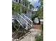 Inviting two-story home with white siding, front porch, and beautifully landscaped yard at 324 Wild Horse Ln, Mount Pleasant, SC 29464